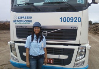 Mulher ao volante no transporte de madeira